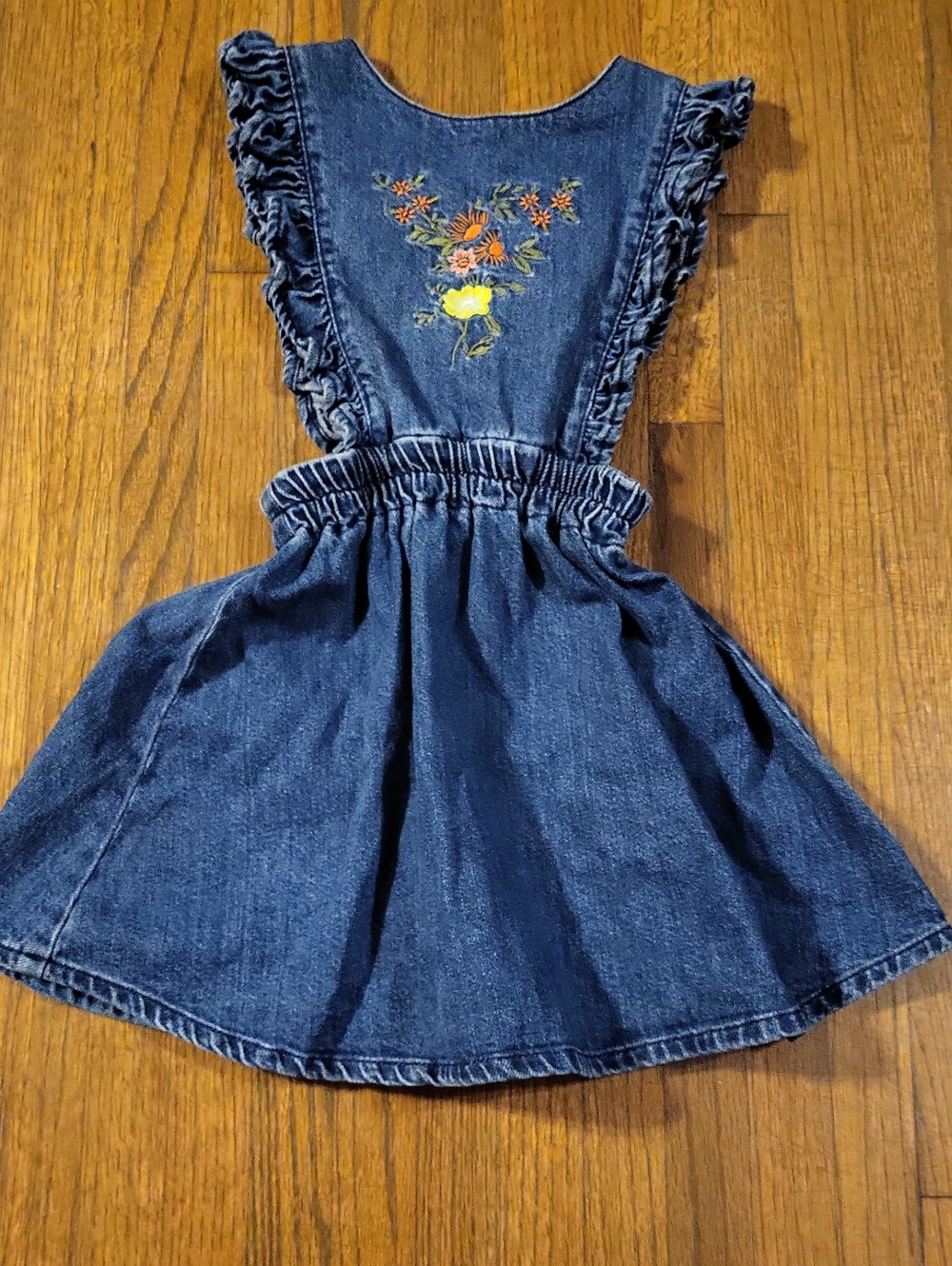 The New Society Boutique Denim Embroidered Ruffle Pinafore Dress in Dark Blue